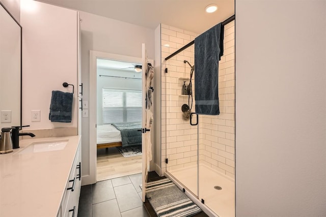 bathroom featuring a shower stall, vanity, connected bathroom, and tile patterned floors