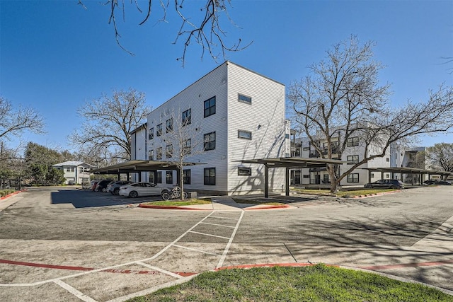 view of building exterior with covered parking