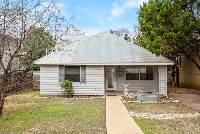 view of front facade featuring a front yard and metal roof