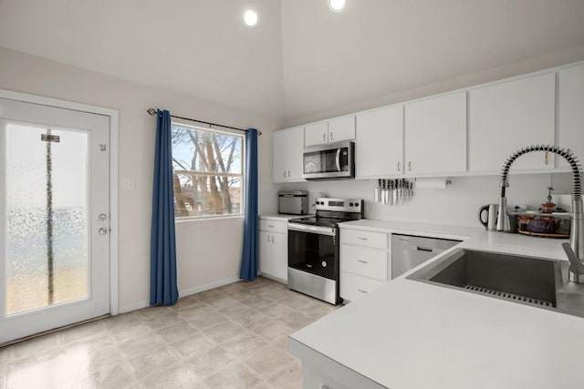 kitchen with white cabinetry, appliances with stainless steel finishes, light countertops, and a sink