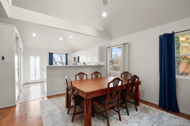 dining space featuring lofted ceiling, light wood finished floors, baseboards, and recessed lighting