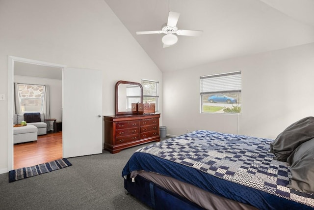 carpeted bedroom featuring high vaulted ceiling and a ceiling fan