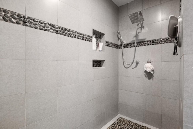 full bath with a tile shower