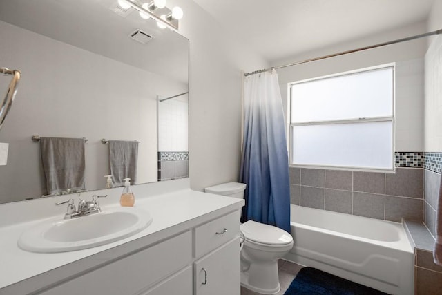 bathroom featuring toilet, visible vents, shower / tub combo with curtain, and vanity