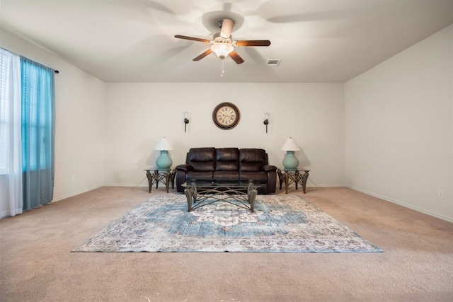 carpeted living area with baseboards, visible vents, and a ceiling fan