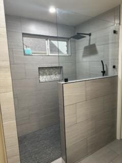 bathroom featuring walk in shower and tile patterned floors