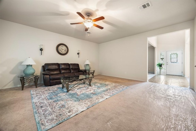 carpeted living room with ceiling fan, visible vents, and baseboards