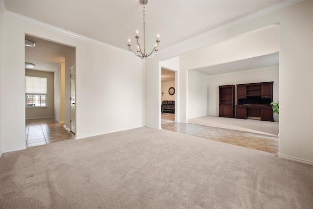 carpeted spare room with a chandelier, crown molding, and tile patterned floors