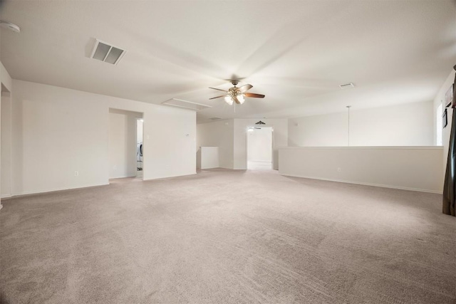 spare room featuring light carpet, baseboards, visible vents, and a ceiling fan