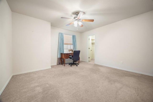 unfurnished office featuring ceiling fan, carpet flooring, and baseboards