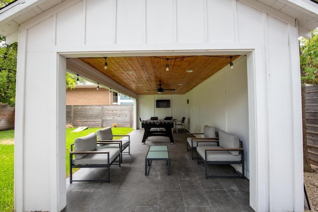 view of patio / terrace featuring ceiling fan, fence, and an outdoor living space