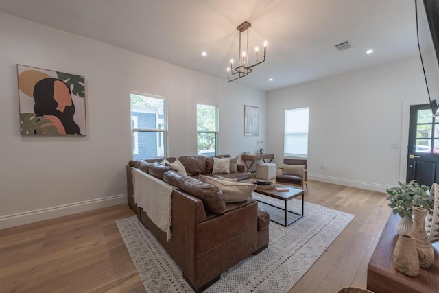 living room with light wood-type flooring, baseboards, visible vents, and recessed lighting