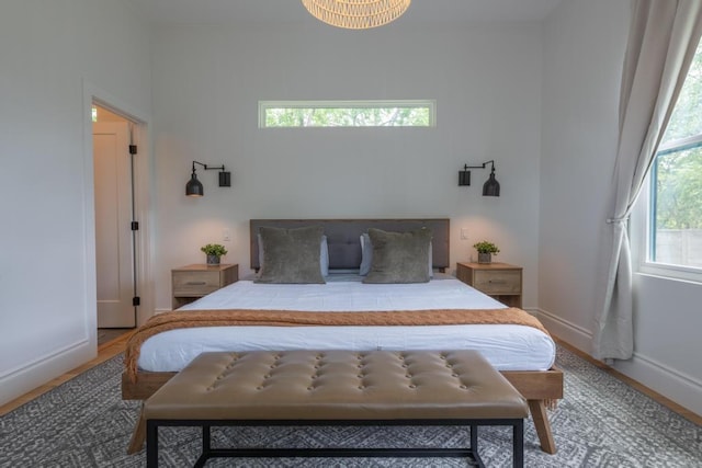 bedroom with baseboards and wood finished floors