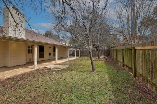 view of yard with a fenced backyard and a patio