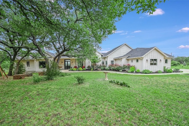 view of front of house with board and batten siding and a front yard