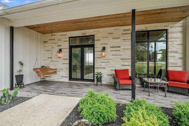 property entrance featuring a patio area, brick siding, and an outdoor hangout area