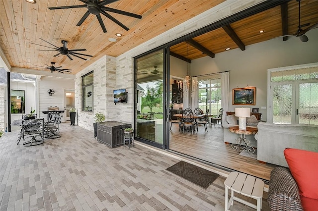 exterior space featuring wood ceiling and beam ceiling