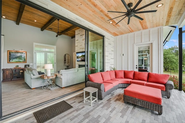 living area with plenty of natural light, beamed ceiling, wooden ceiling, and recessed lighting