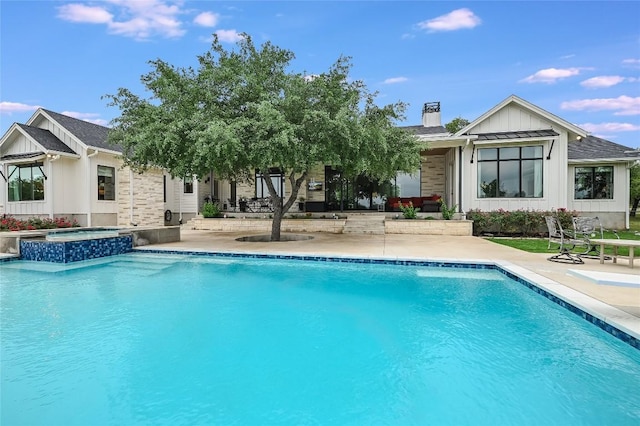 view of pool featuring a pool with connected hot tub and a patio