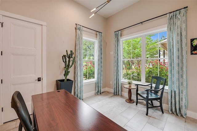 home office featuring baseboards and light tile patterned floors