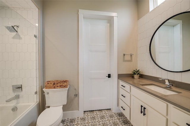 bathroom with bathing tub / shower combination, toilet, vanity, baseboards, and tile patterned floors