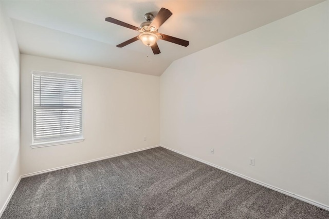 unfurnished room featuring vaulted ceiling, ceiling fan, dark carpet, and baseboards