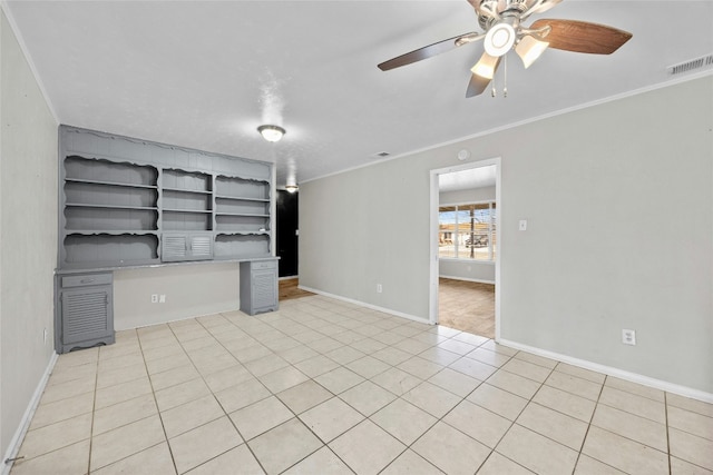 interior space featuring baseboards, visible vents, ornamental molding, and built in study area