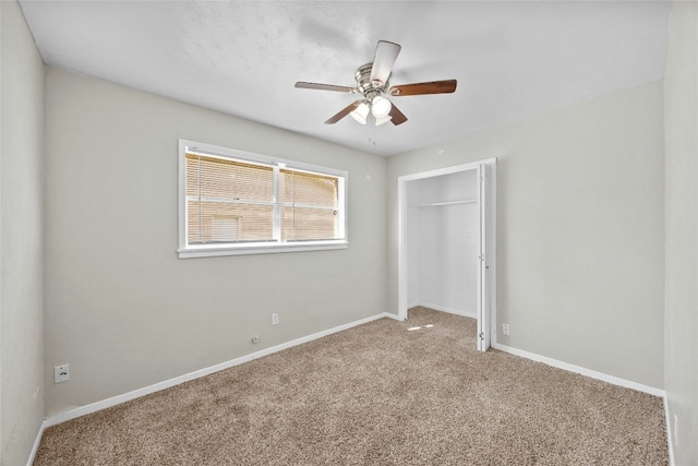 unfurnished bedroom featuring a closet, carpet flooring, a ceiling fan, and baseboards