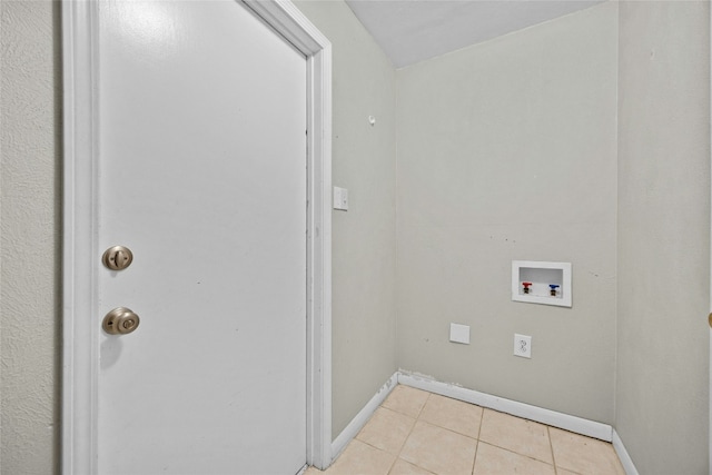 laundry room featuring washer hookup, laundry area, baseboards, and light tile patterned floors