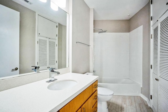 bathroom with shower / washtub combination, a closet, vanity, and toilet