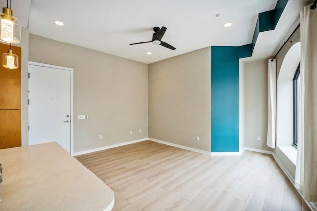 507 Sabine St Unit 1010, Austin, TX 78701 - empty room featuring ceiling fan, light wood finished floors, baseboards, and recessed lighting