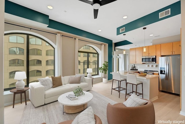 living area featuring visible vents, recessed lighting, a ceiling fan, and light wood-style floors