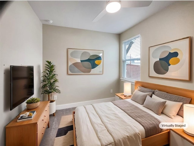 carpeted bedroom featuring ceiling fan and baseboards