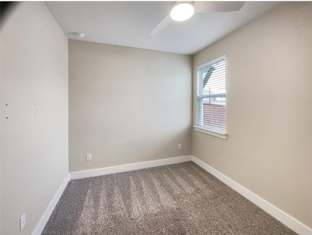 empty room with carpet floors, a ceiling fan, and baseboards