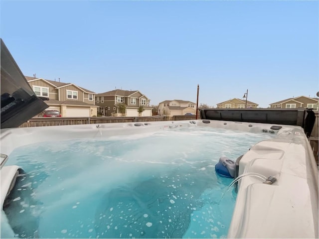 view of swimming pool featuring a fenced backyard and a residential view