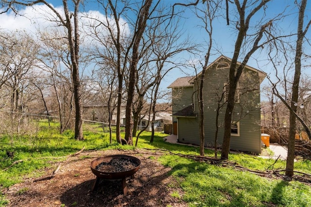 view of yard featuring a fire pit and fence