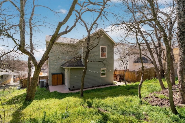 back of house with a yard and fence