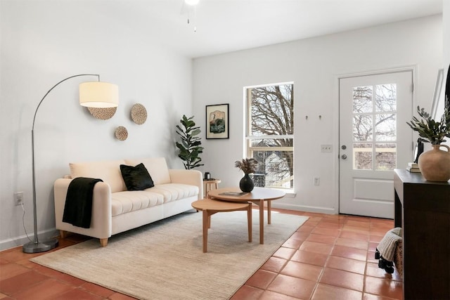 living room with baseboards and light tile patterned floors