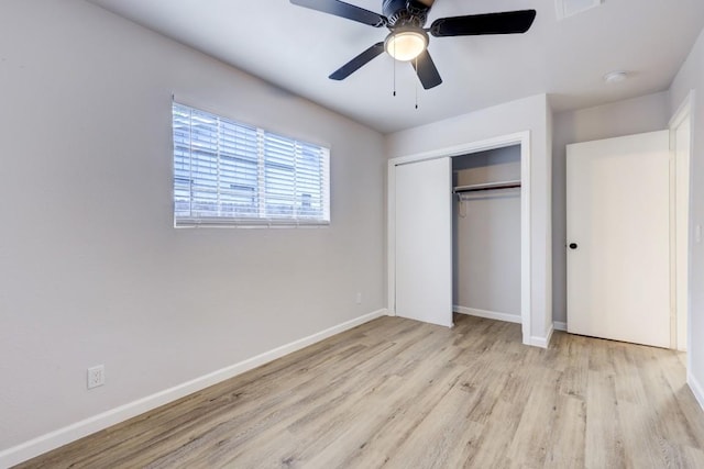 unfurnished bedroom featuring ceiling fan, a closet, wood finished floors, and baseboards