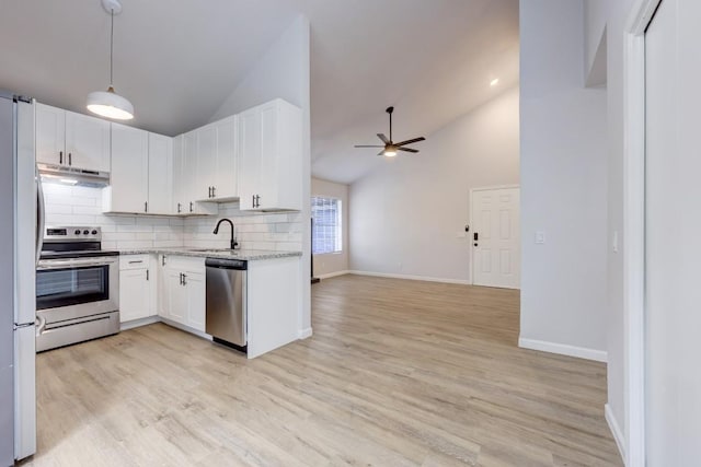 kitchen featuring under cabinet range hood, a ceiling fan, appliances with stainless steel finishes, light stone countertops, and light wood finished floors