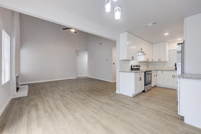 kitchen with visible vents, backsplash, appliances with stainless steel finishes, white cabinets, and light wood-type flooring