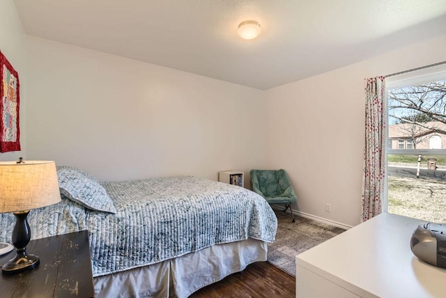 bedroom featuring baseboards and wood finished floors