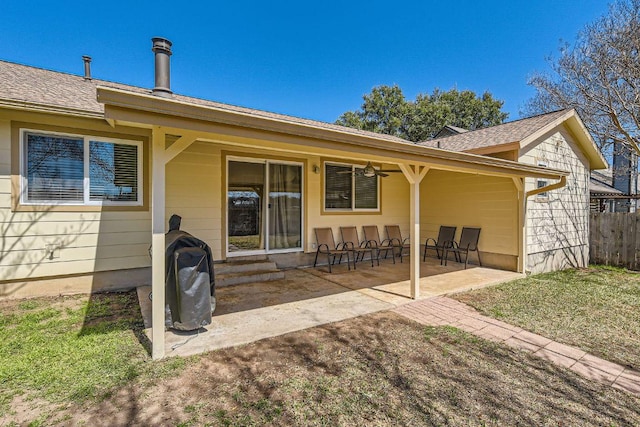 back of house featuring a patio area, fence, and roof with shingles