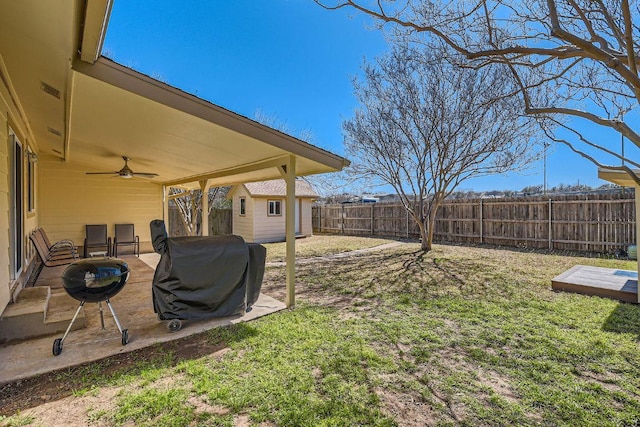 view of yard with a ceiling fan, an outbuilding, a patio area, and a fenced backyard