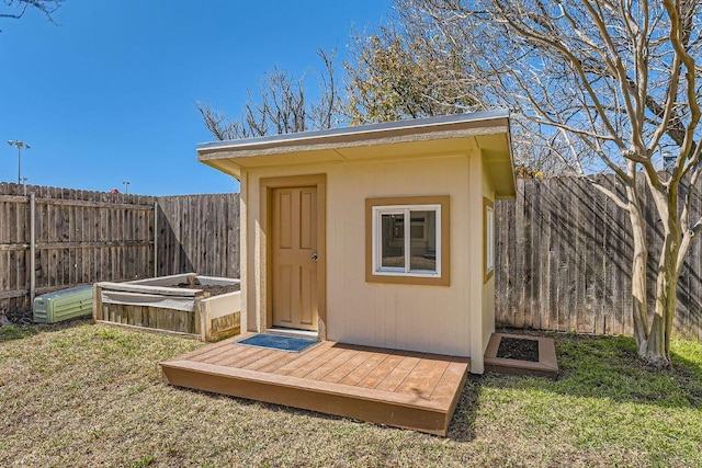 view of shed with a fenced backyard and a vegetable garden