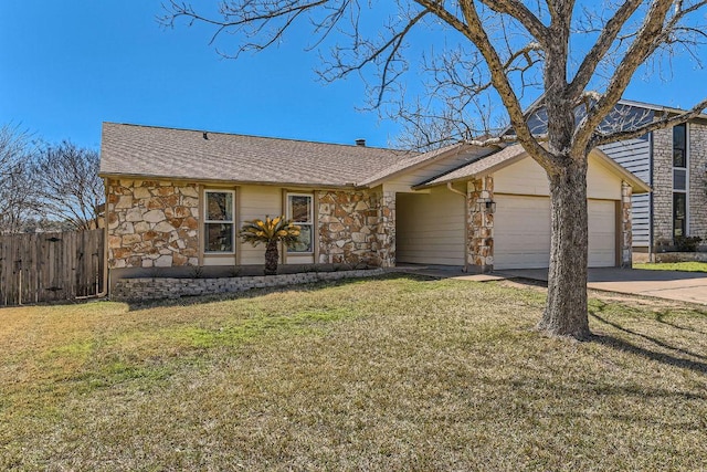 view of front of property featuring a front lawn, stone siding, fence, and an attached garage