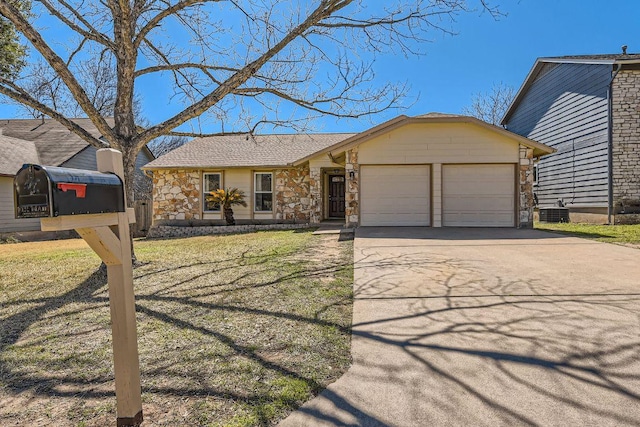 view of front of property with a garage, a shingled roof, stone siding, concrete driveway, and a front yard