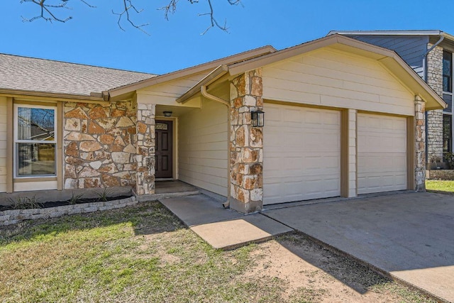 view of front of property with a garage, stone siding, a shingled roof, and concrete driveway