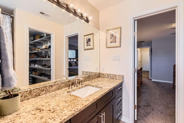 full bathroom featuring vanity, visible vents, and baseboards