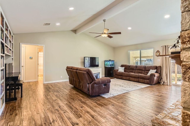 living room with lofted ceiling with beams, a fireplace, wood finished floors, visible vents, and a ceiling fan